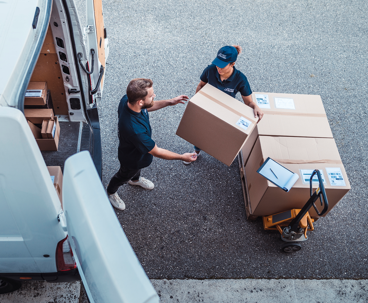 Delivery workers handling packages by van.