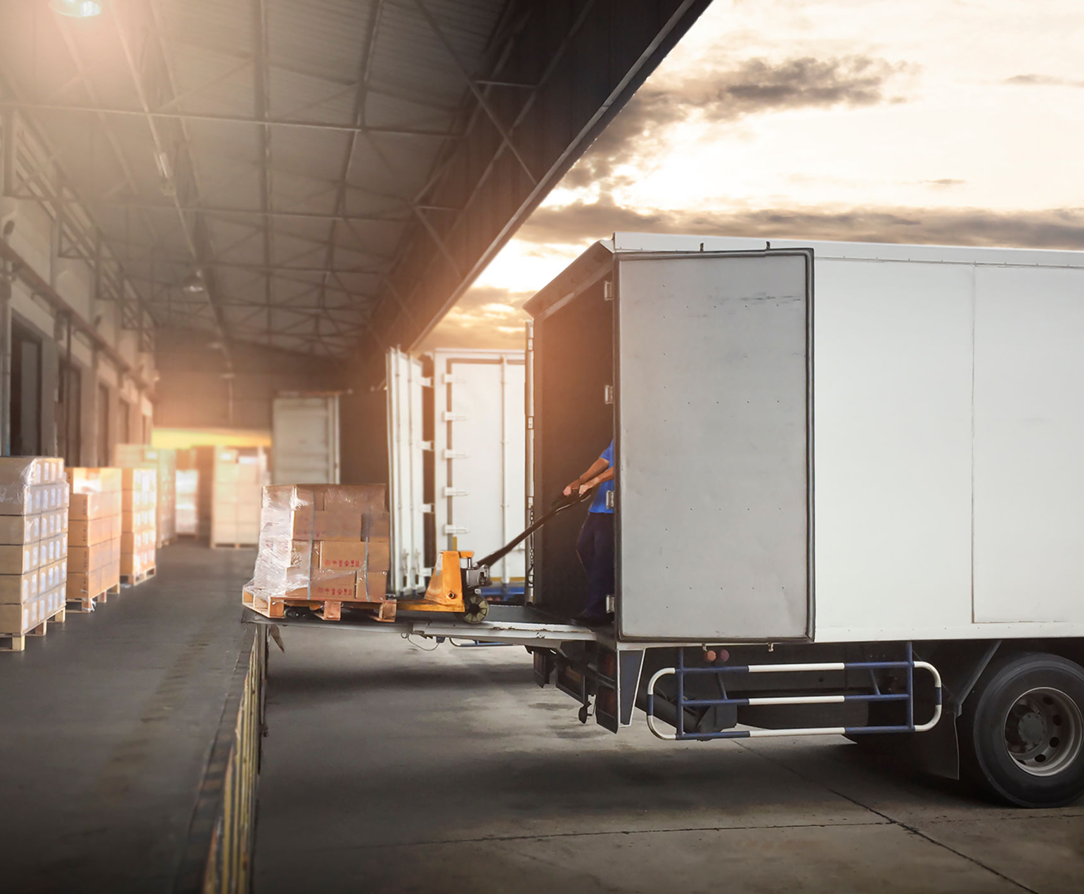 Truck unloading goods at loading dock.