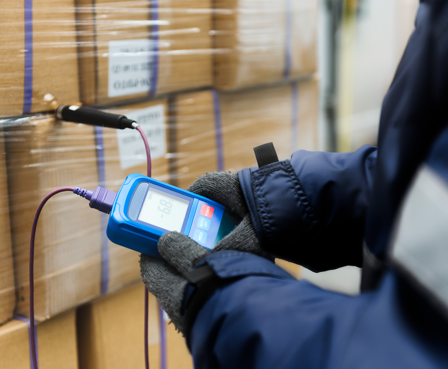 Person using a handheld measuring device.